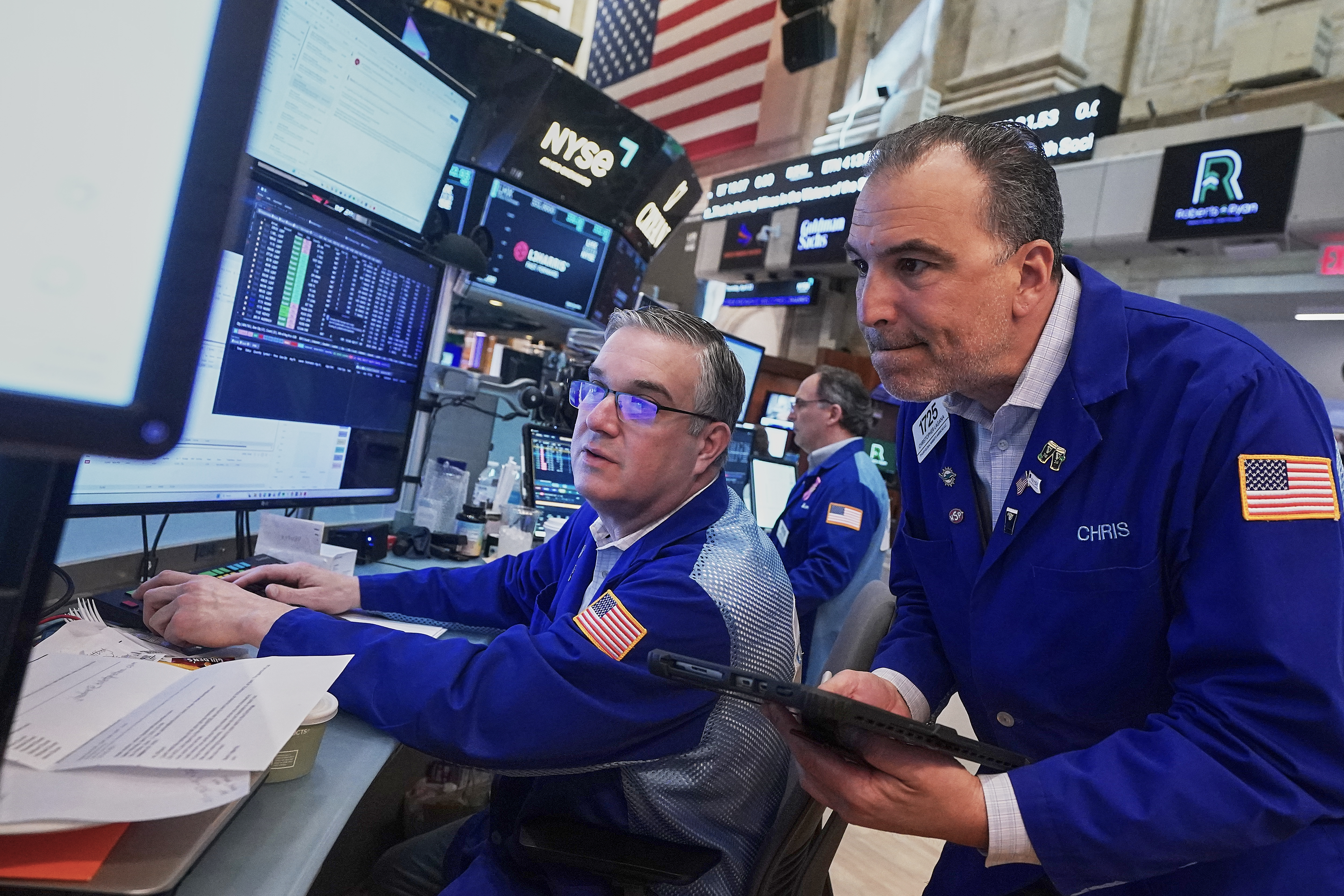 Traders Jim Bodner, left, and Chris Lagana work on the floor of the New York Stock Exchange, Thursday, April 23, 2026.
