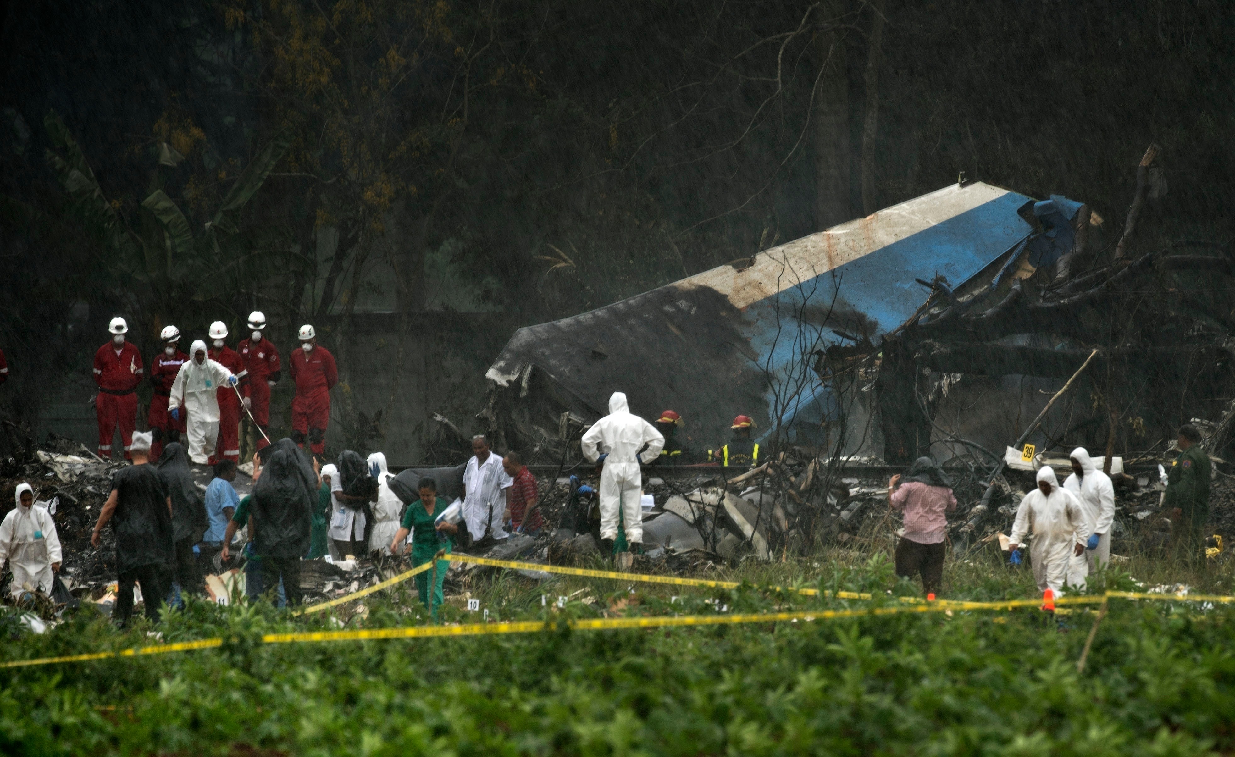 Rescue teams search through the wreckage site of a Boeing 737 that plummeted into a cassava field with more than 100 passengers on board, in Havana, Cuba, May 18, 2018.