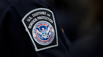 A customs agent wears a patch for the U.S. Customs and Border Protection agency, Oct. 27, 2017, at John F. Kennedy International Airport in New York.