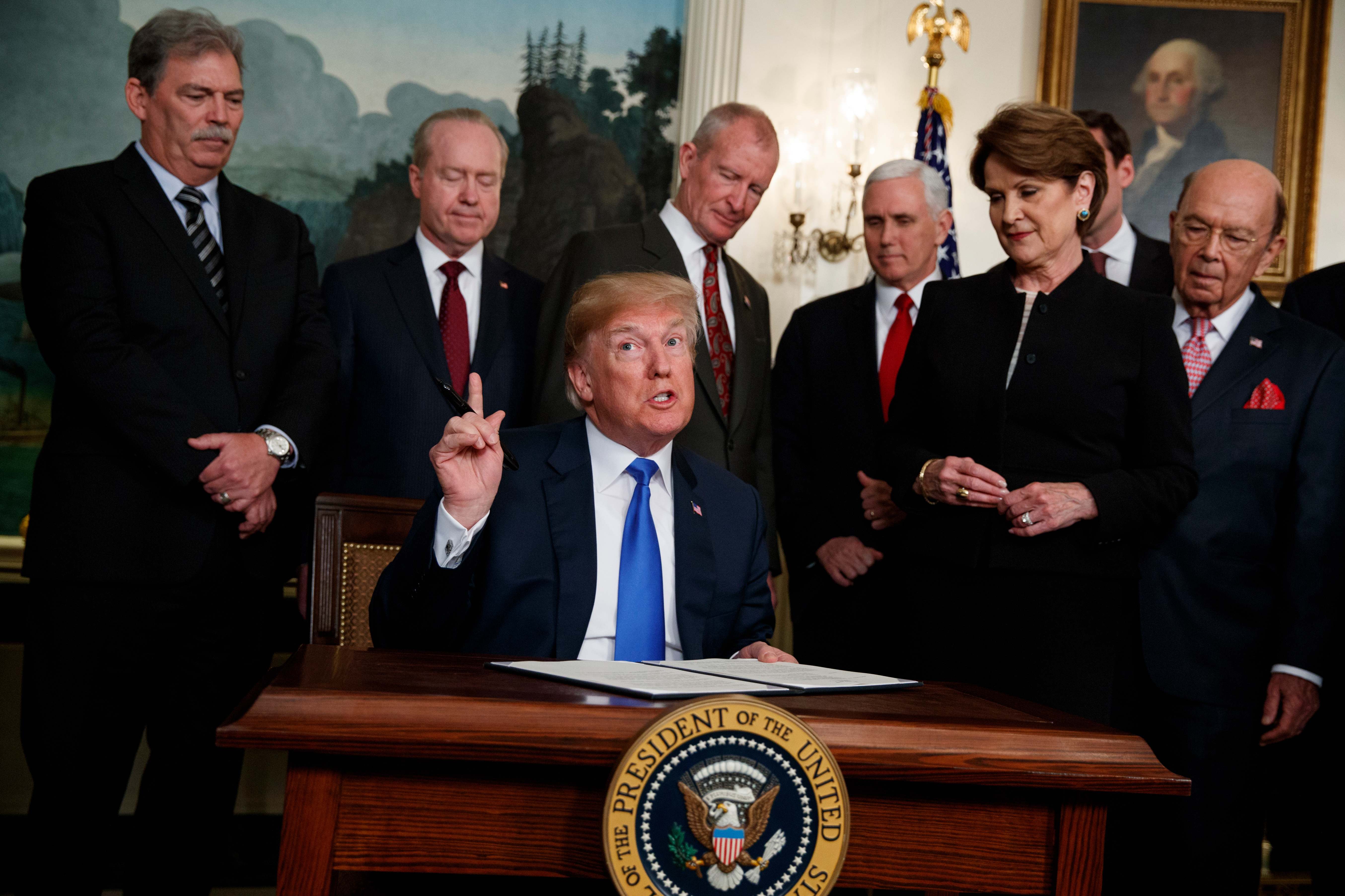 President Donald Trump speaks before he signs a presidential memorandum imposing tariffs and investment restrictions on China in the Diplomatic Reception Room of the White House, March 22, 2018, in Washington.