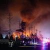 Plumes of smoke rise from the area of a UPS cargo plane crash at Louisville Muhammad Ali International Airport, Nov. 4, 2025, in Louisville, Ky.