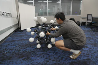 Jiaxun Liu, a Ph.D. student, works on a robot named Argus at Duke University's General Robotics Lab in Durham, N.C., Tuesday, May 26, 2026.