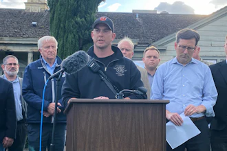 Longview Fire Department Battalion Chief Matt Amos speaks at a press conference in Longview, Wash., Tuesday, May 26, 2026, at the site of a paper mill where a chemical tank failure killed at least one person and left others unaccounted for.