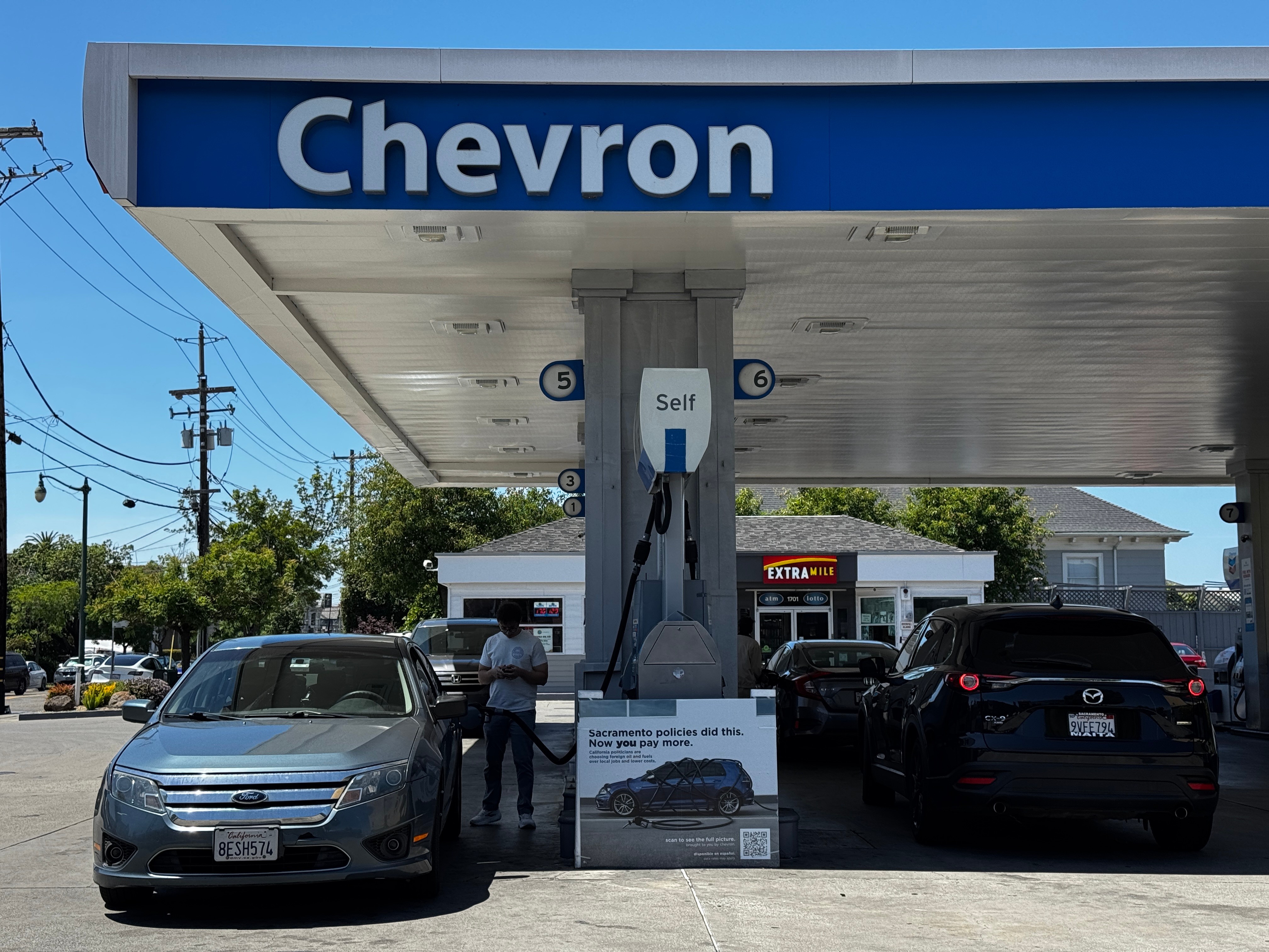 A sign blaming Sacramento policies for high gas prices is displayed at a Chevron gas station in Alameda, Calif., on Thursday, May 21, 2026.
