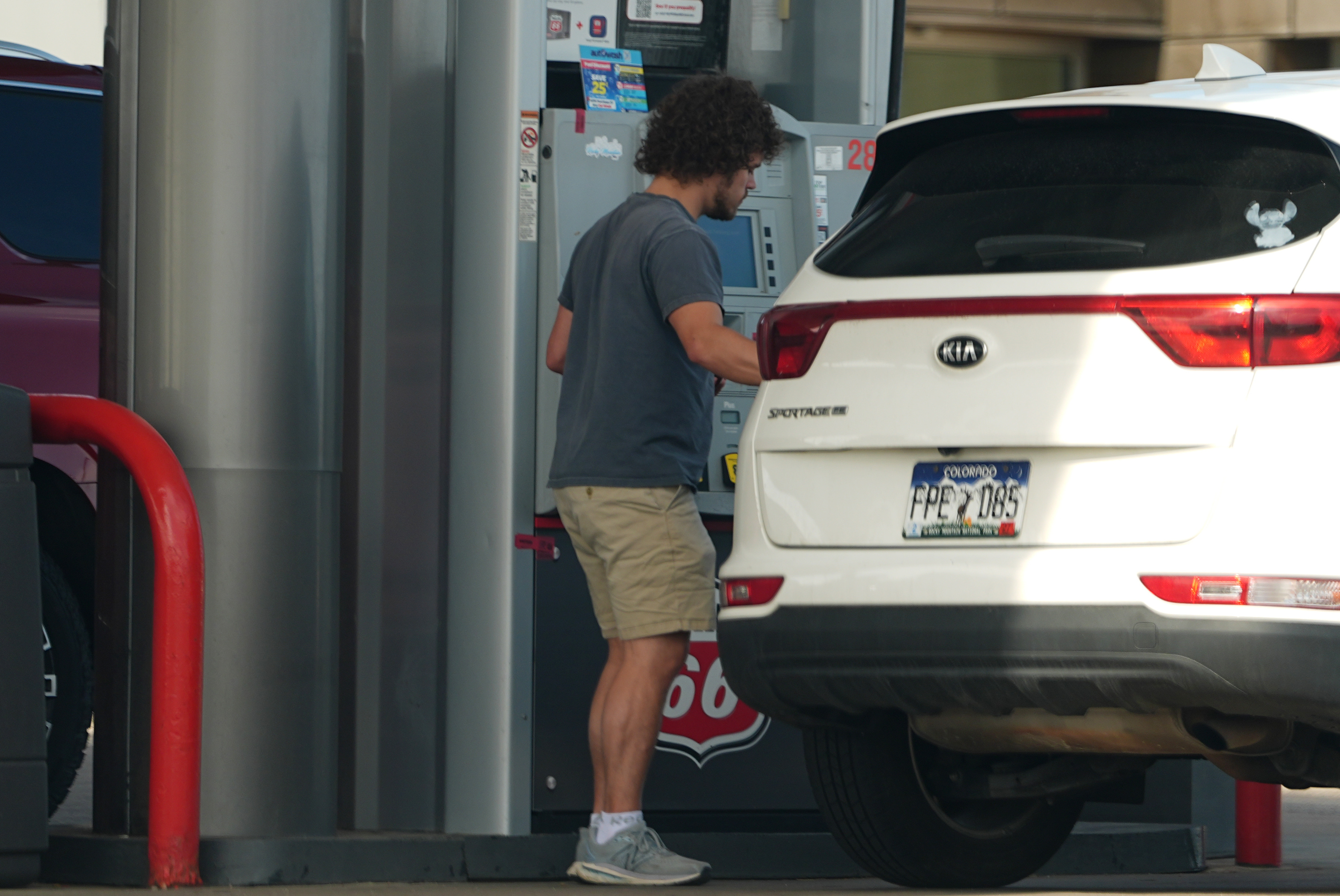 A motorist fills up the tank of a utility vehicle at a Phillips 66 gasoline station at Denver International Airport Saturday, May 9, 2026, in Denver.