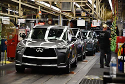 A worker walks past a line of Infiniti SUVs on a production line at the Nissan Smyrna Vehicle Assembly Plant, Thursday, April 16, 2026, in Smyrna, Tenn.