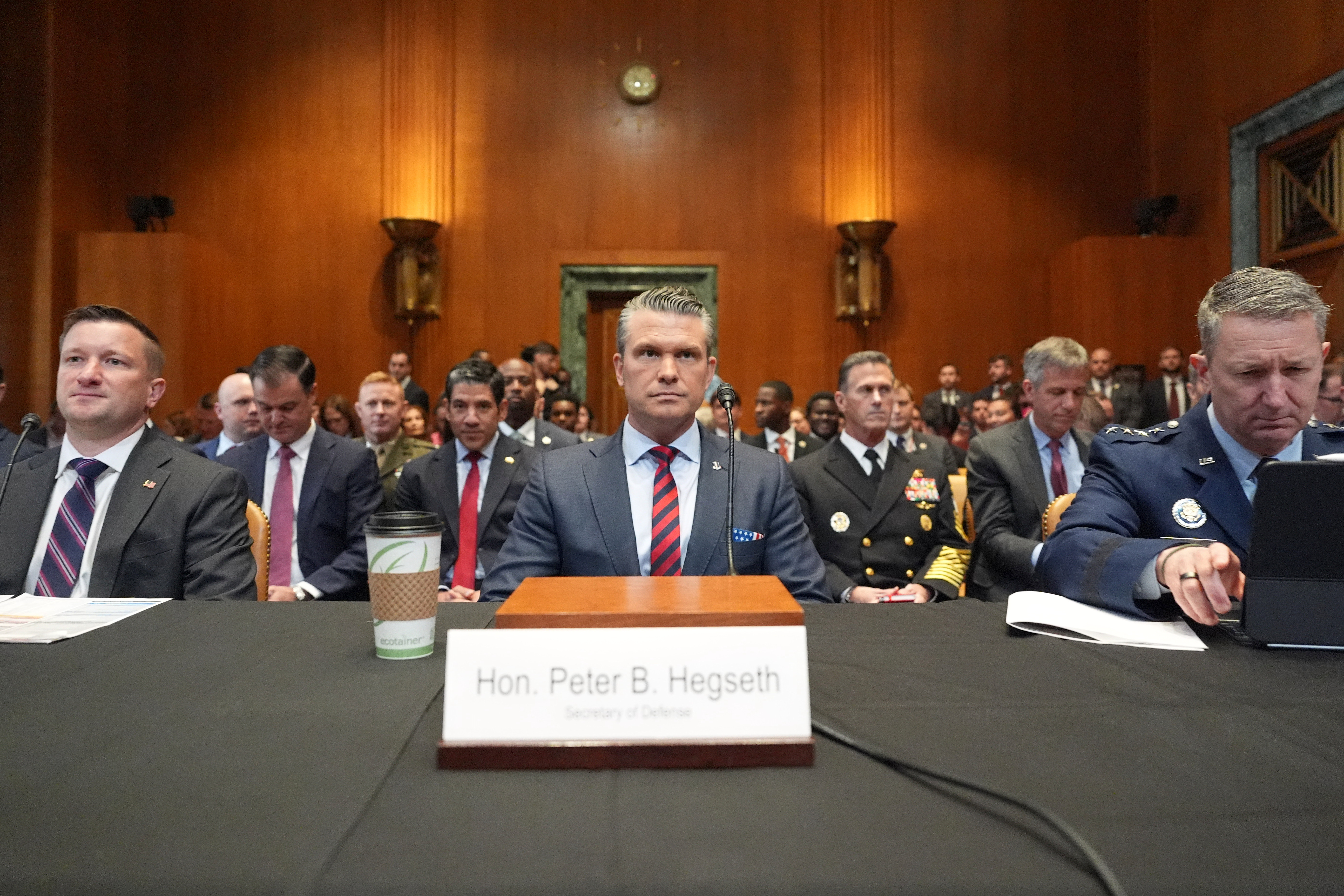 Acting Under Secretary of Defense and Comptroller Jules Hurst III, Defense Secretary Pete Hegseth and Chairman of the Joint Chiefs of Staff Gen. Dan Caine arrive to testify at a Senate Appropriations subcommittee on defense hearing on the budget request for the Department of Defense, Tuesday, May 12, 2026, in Washington.
