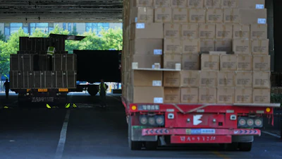 Workers transfer goods from a truck at the Xiaomi logistic center, Beijing, May 29, 2026.