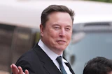 Elon Musk departs after a welcome ceremony with President Donald Trump and China's President Xi Jinping at the Great Hall of the People, May 14, 2026, Beijing.