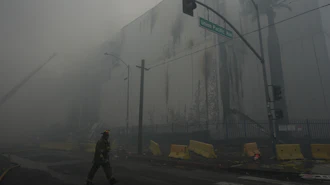 Smoke from a warehouse fire fills the air in the Boyle Heights neighborhood of Los Angeles, June 21, 2026.