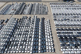 An aerial view of new cars awaiting export to oversea markets is seen at a port in Shanghai, March 10, 2026.