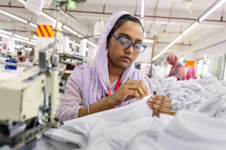 Ruma Aktar, a sewing machine operator, wears her prescription eyeglasses while working at a garment factory in Gazipur, on the outskirts of Dhaka, Bangladesh, June 30, 2026.