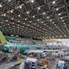 Boeing employees work on a 737 MAX airplane on the final assembly line at Boeing's plant in Renton, Wash., on June 15, 2022.
