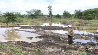 Martha Waema stands on her farm after it was submerged by weeks of rainfall, Machakos, Kenya, May 8, 2024.