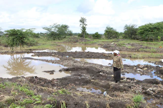 Martha Waema stands on her farm after it was submerged by weeks of rainfall, Machakos, Kenya, May 8, 2024.