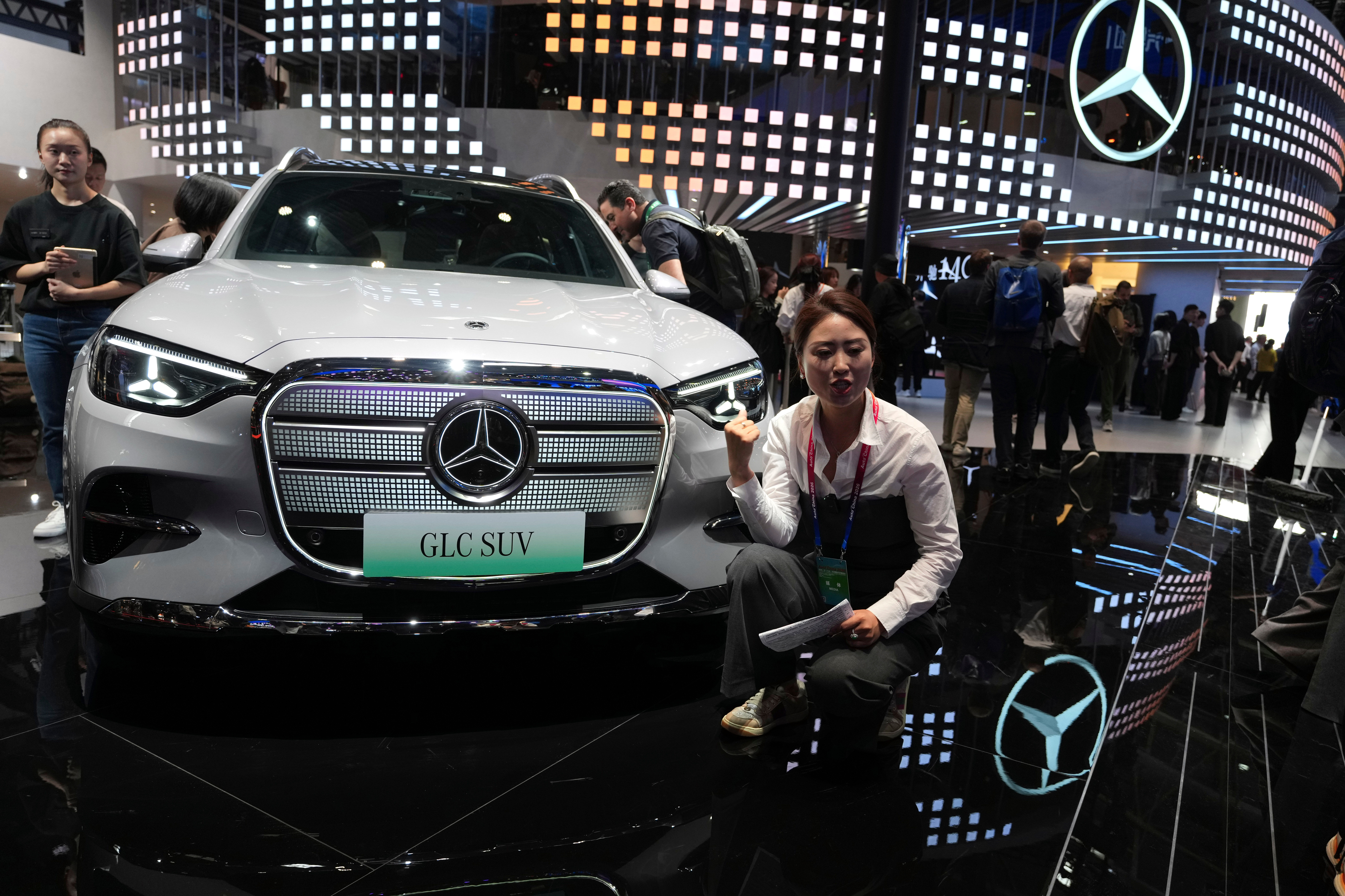 A vlogger promotes the GLC SUV at the Mercedes-Benz booth during Auto China 2026 in Beijing, on April 24, 2026. Major German carmakers saw sharp quarterly sales declines in China, as domestic demand weakened and competition heats up in the world&rsquo;s biggest auto market.
