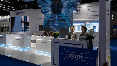 Workers at the booth for Chinese DRAM producer ChangXin Memory Technologies, also known as CXMT, wait for visitors at the 21st China International Semiconductor Expo in Beijing, Nov. 20, 2024.