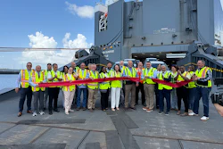 Rob Madden, Mitsubishi Motors North America, Inc., (center, with scissors) cuts the ceremonial ribbon to celebrate Port Freeport as a new U.S. distribution port for the company’s vehicles, as new Mitsubishi vehicles roll off the Höegh Sunrise.