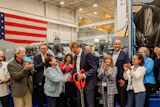 Jörg Stratmann, CEO of Rolls-Royce Power Systems, and Najwa Massad, Mayor of Mankato, at the opening of Rolls-Royce's new Logistics Operations Center in Mankato, USA. Representatives from politics, business, and the company were present for the official inauguration of the $24 million expansion.