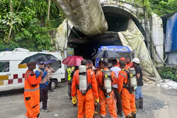 Members of the rescue team carry oxygen cylinders outside the entrance to an under-construction tunnel at a hydropower project in Samardung village, about 40 kilometers (25 miles) from Gangtok, India, Tuesday, July 21, 2026.