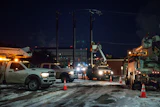 An Oncor Electric Delivery lineman crew work on repairing a utility pole that was damaged by the winter storm that passed through Odessa, Texas, Feb. 18, 2021.