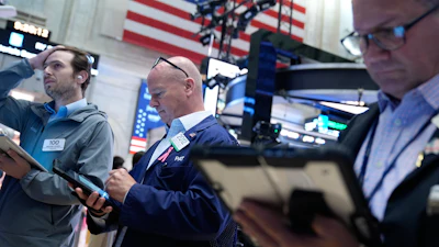 Traders work on the floor at the New York Stock Exchange in New York, Monday, July 6, 2026.
