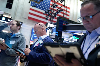 Traders work on the floor at the New York Stock Exchange in New York, Monday, July 6, 2026.