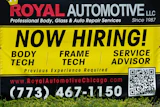 A now hiring sign is seen in front of an auto body shop in Chicago, June 25, 2026.