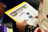 A job seeker waits to talk to a recruiter at a job fair in Sunrise, Fla., Aug. 28, 2025.