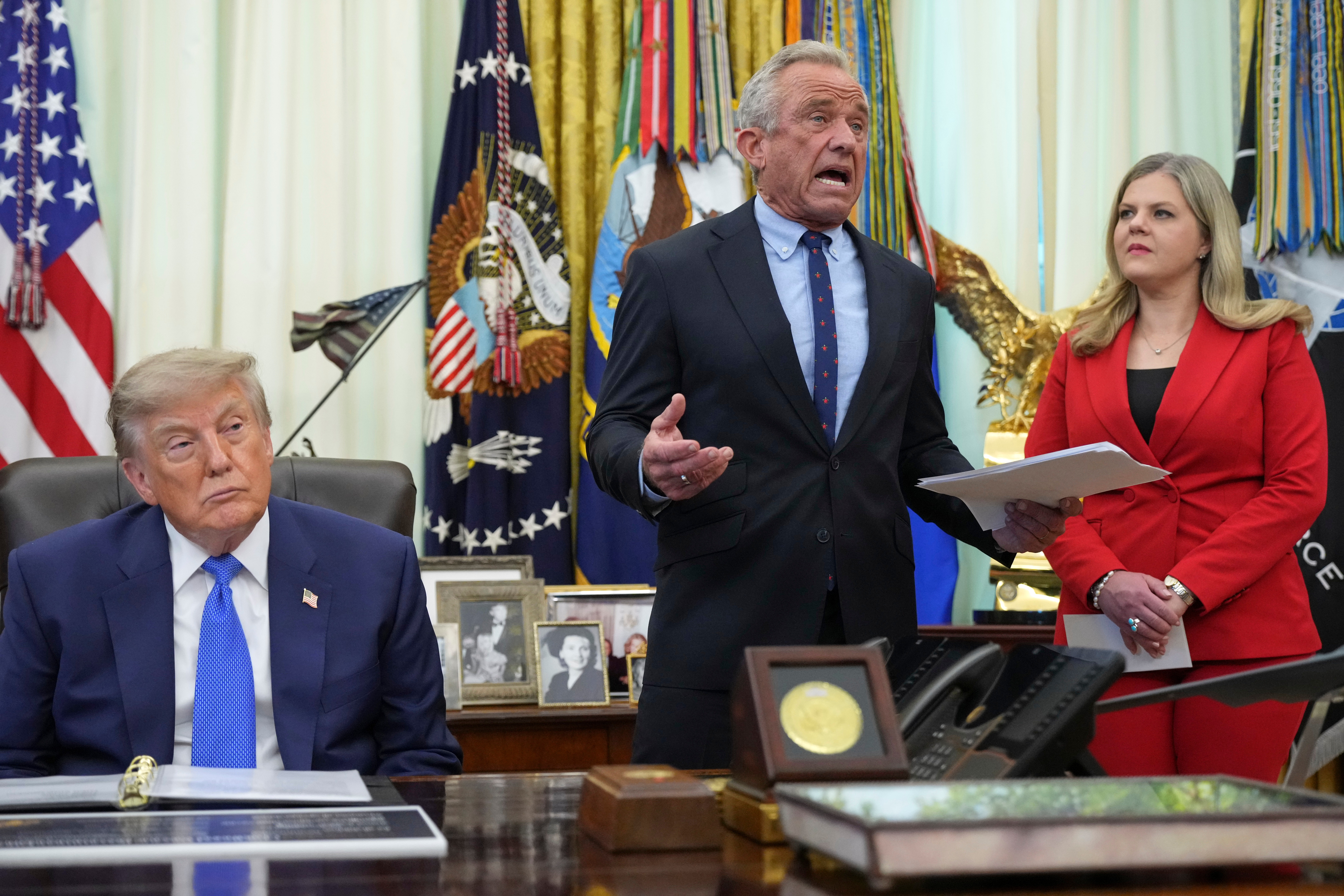 Health and Human Services Secretary Robert F. Kennedy Jr. speaks alongside President Donald Trump and Heidi Overton, deputy director of the White House Domestic Policy Council, in the Oval Office, Aug. 10, 2026.
