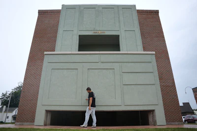Wesley Mast, owner and president of Coppes Napanee, walks past a giant replica of a Hoosier cabinet in Nappanee, Ind., Thursday, Aug. 6, 2026.
