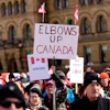 Signs at a rally on Parliament Hill in Ottawa, March 9, 2025.