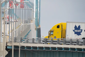Transport trucks cross the Ambassador Bridge into the U.S. in Windsor, Ontario, Aug. 22, 2026.
