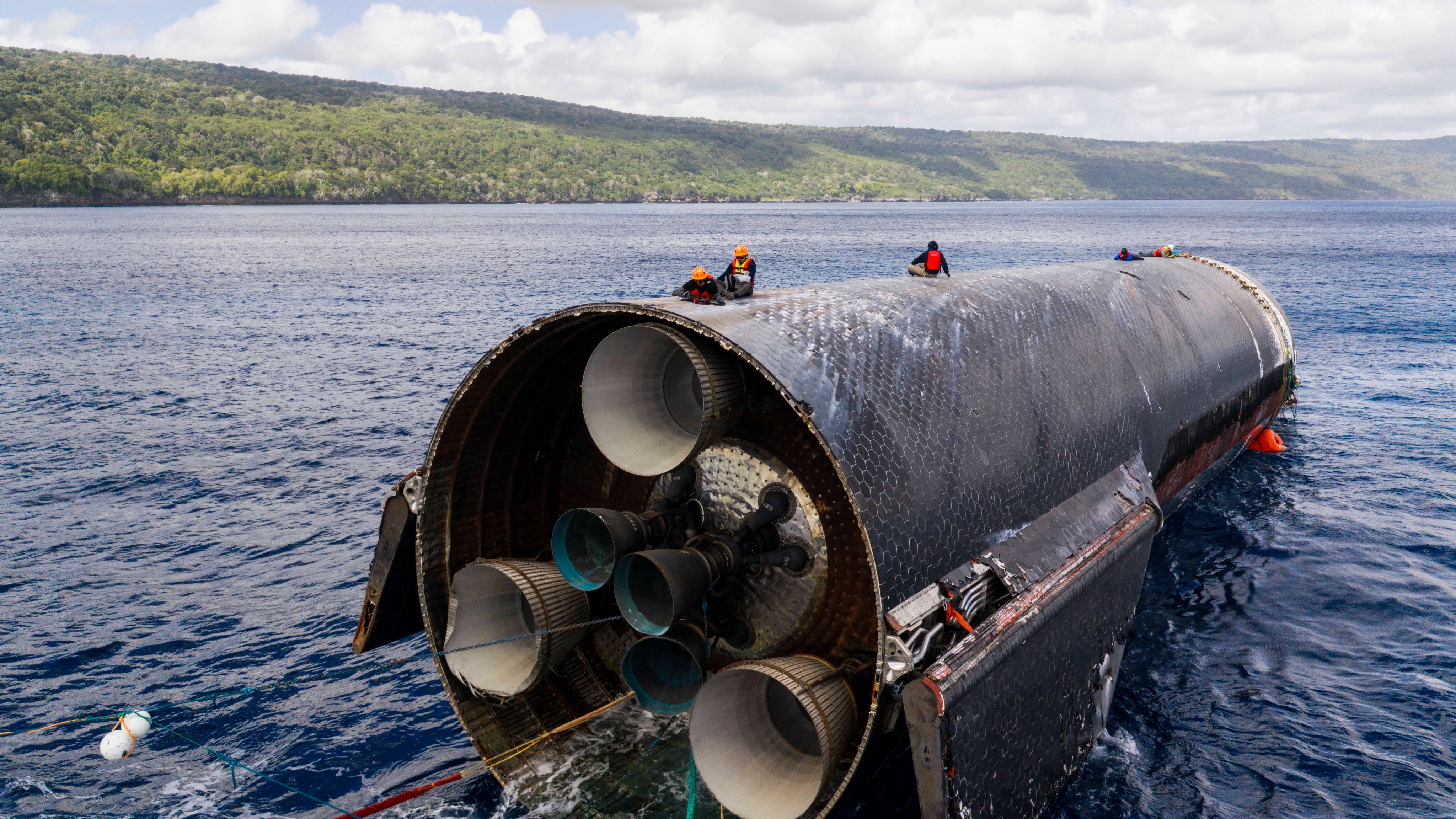 This image provided by SpaceX on Aug. 27, 2026, shows engineers inspecting Starship off the coast of Christmas Island in the Indian Ocean, following its launch on a test flight back in July.