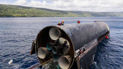 This image provided by SpaceX on Aug. 27, 2026, shows engineers inspecting Starship off the coast of Christmas Island in the Indian Ocean, following its launch on a test flight back in July.