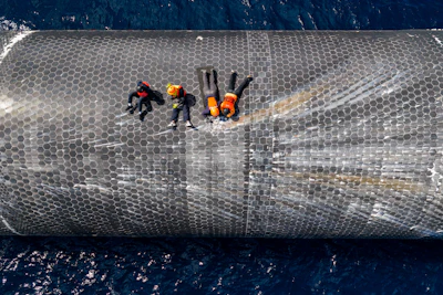 This image provided by SpaceX on Aug. 27, 2026, shows engineers inspecting Starship off the coast of Christmas Island in the Indian Ocean, following its launch on a test flight back in July.