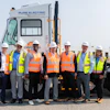 Orange EV and APM Terminals team members gather alongside an Orange EV electric terminal truck.