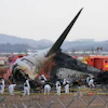 Rescue team members work at the site of a plane crash at Muan International Airport in Muan, South Korea on Dec. 31, 2024.