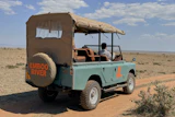 In this photo taken with a smartphone, an electric safari van operated by Emboo Camp drives through the Maasai Mara, Kenya, Saturday, Aug. 29, 2026.