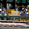 Workers in the manufacturing plant of Ideal Roofing, Ottawa, Aug. 25, 2026.
