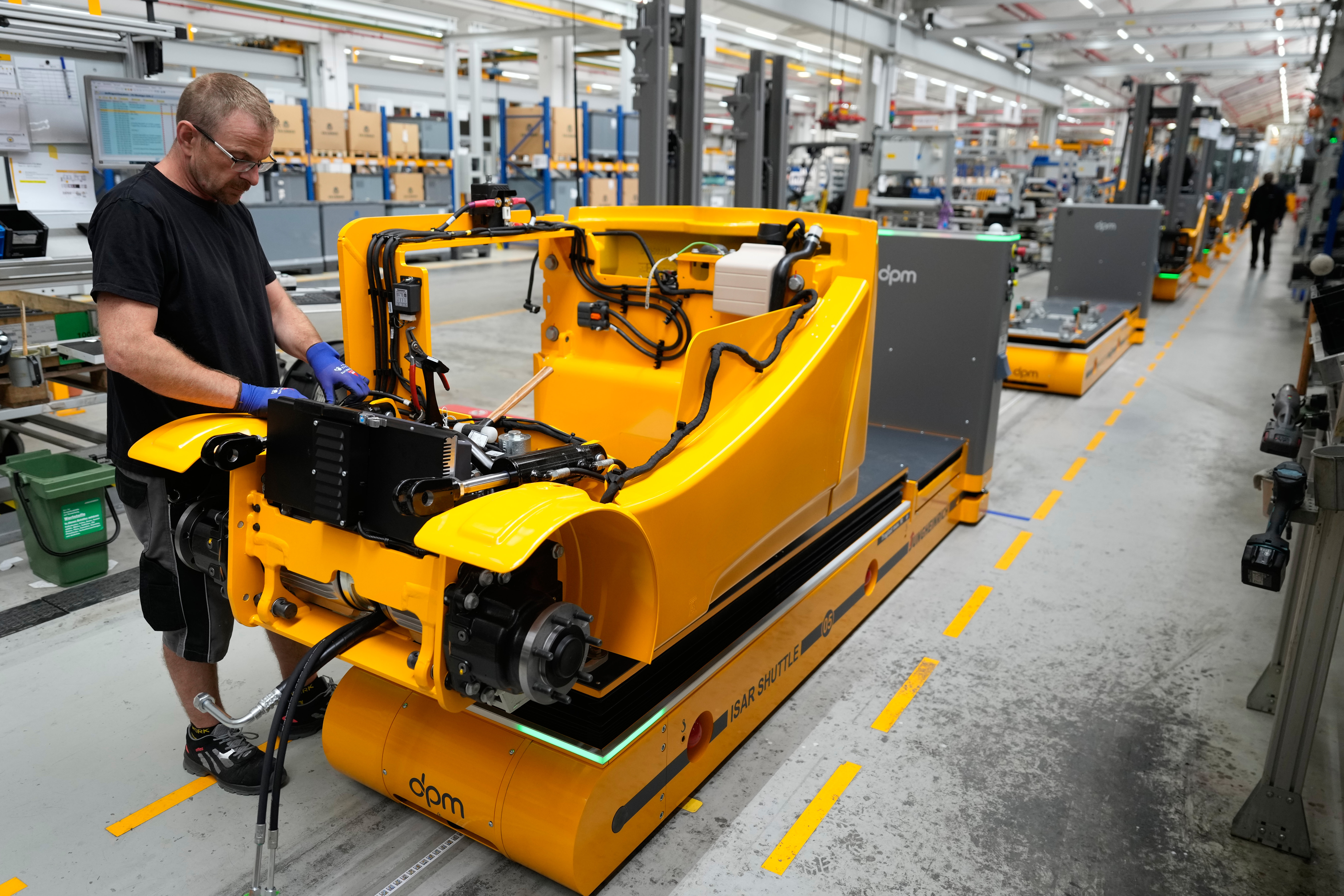 Employees at forklift and warehouse vehicle manufacturer Jungheinrich work on the assembly line in Moosburg, Germany, Aug. 25, 2026.