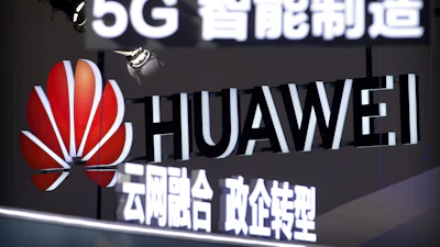 Signs promoting 5G wireless technology from Chinese technology firm Huawei are displayed at the PT Expo in Beijing on Sept. 26, 2018.