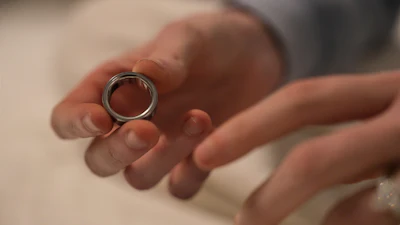 Silver metal ring held in open palm during a tender moment