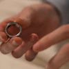 Silver metal ring held in open palm during a tender moment