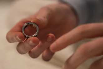 Silver metal ring held in open palm during a tender moment