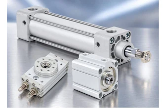 Industrial pneumatic cylinders and compact actuators with metal fittings displayed on reflective surface