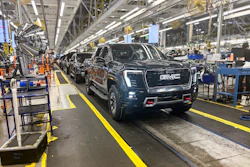 A GMC Sierra EV with battery cells made from recycled materials rolls off the line at GM’s Factory ZERO assembly facility.
