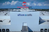 Aerial view of Ultium Cells manufacturing facility with branded signage and loading docks under blue sky