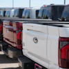 Unsold 2026 F-150 pickup trucks sit in a long line outside a Ford dealership on April 12, 2026, in Centennial, Colo.