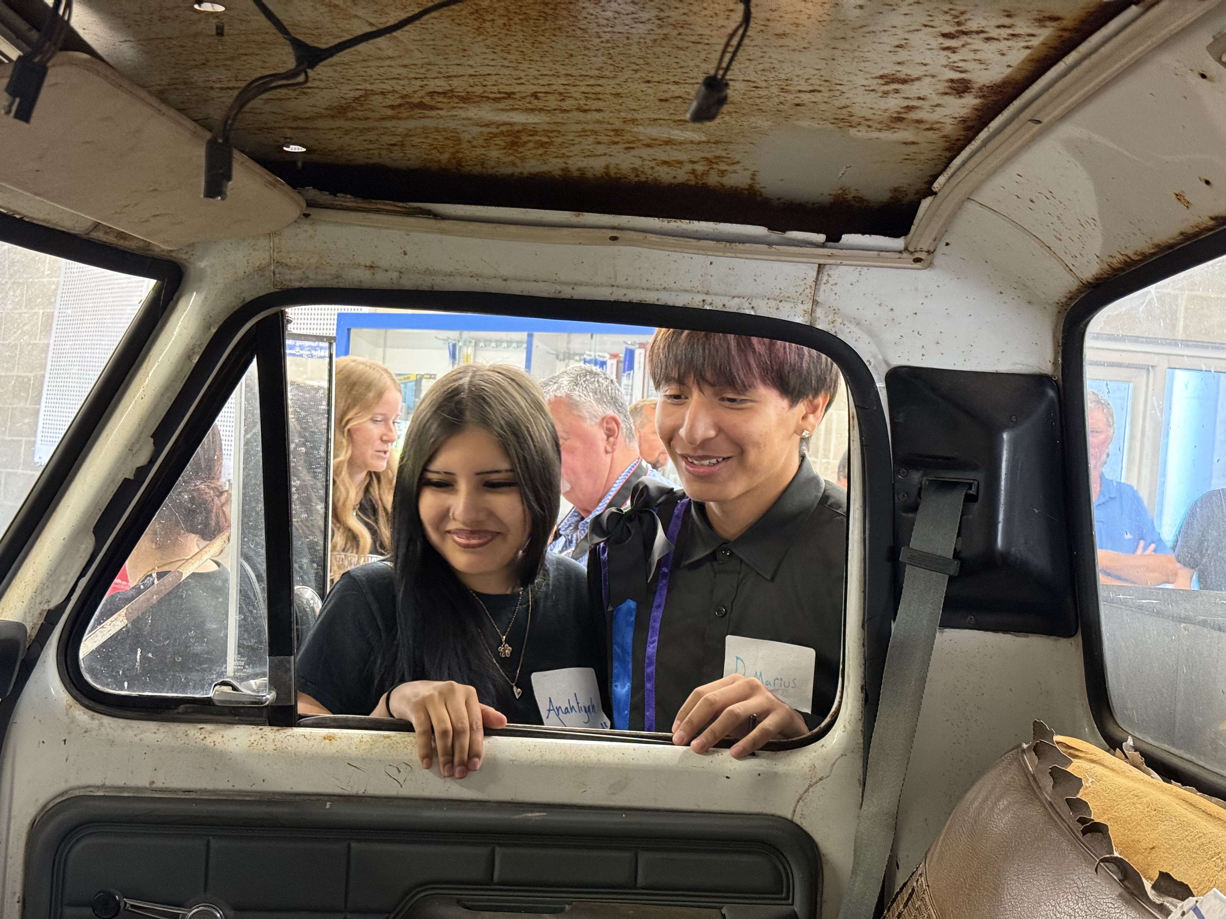 Students from Flandreau Indian School in South Dakota inspect a 1976 Ford F-350 utility truck.
